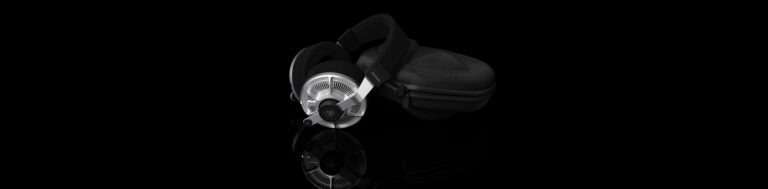 a pair of headphones on a black surface Final Audio DX6000